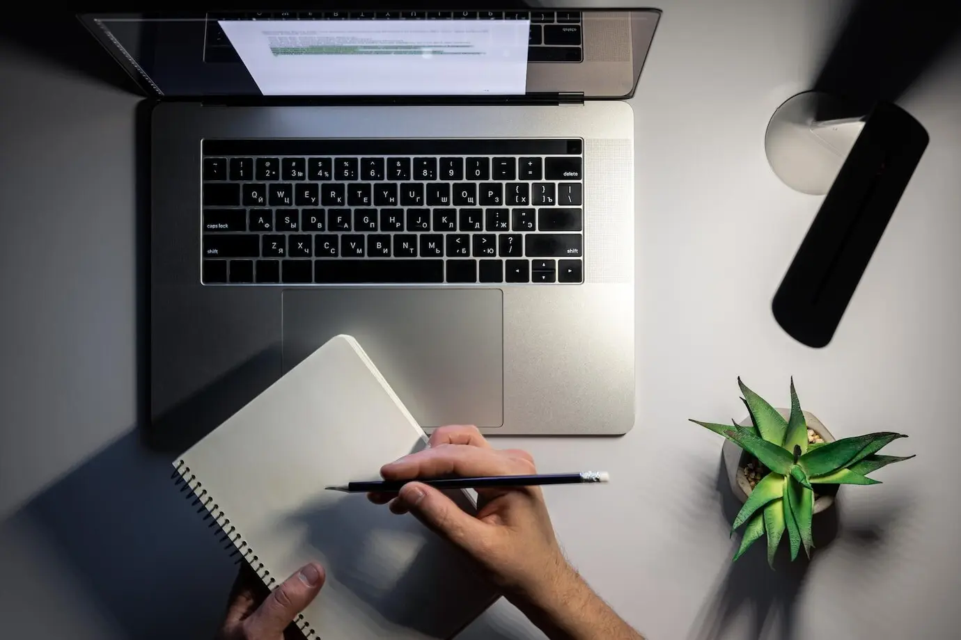 Draufsicht: Laptop und Lampe bei der Arbeit in der Nacht